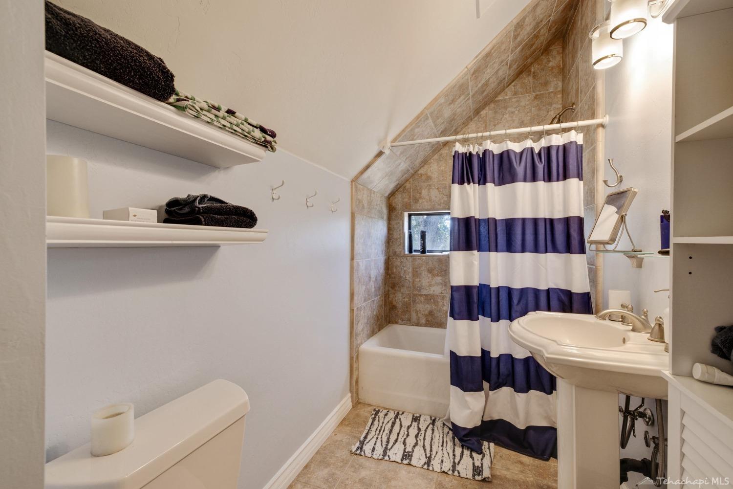24500 Heather Court Tehachapi, CA 93561 - Photo 49 of 60 a bathroom with a sink a toilet and a shower