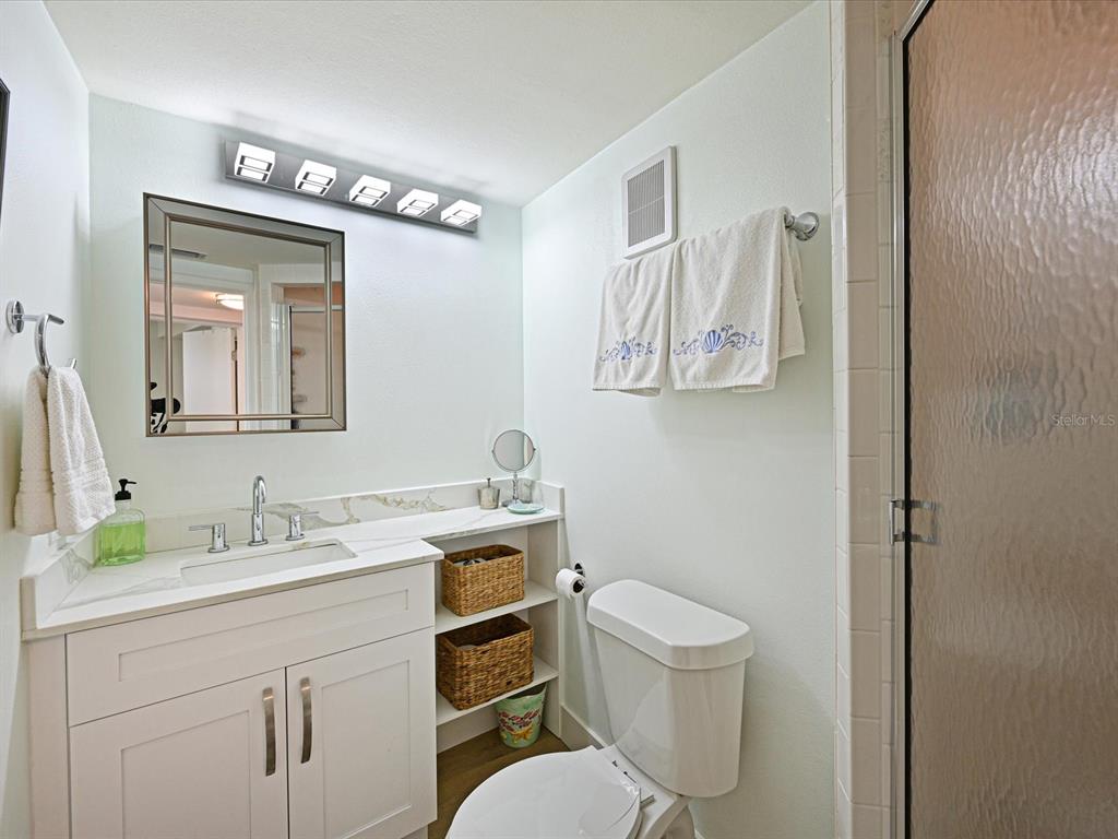 100 Sands Point Road, Unit 225 Longboat Key, FL 34228 - Photo 20 of 32 a bathroom with a toilet sink and mirror