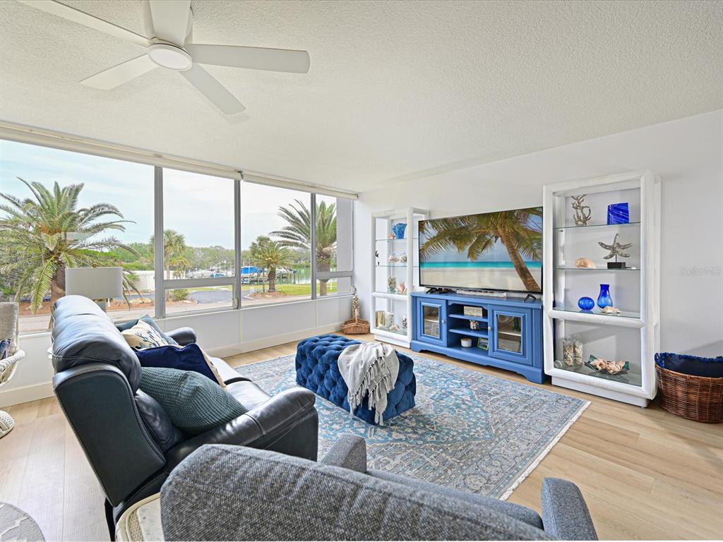 100 Sands Point Road, Unit 225 Longboat Key, FL 34228 - Photo 3 of 32 a living room with fireplace furniture and a flat screen tv