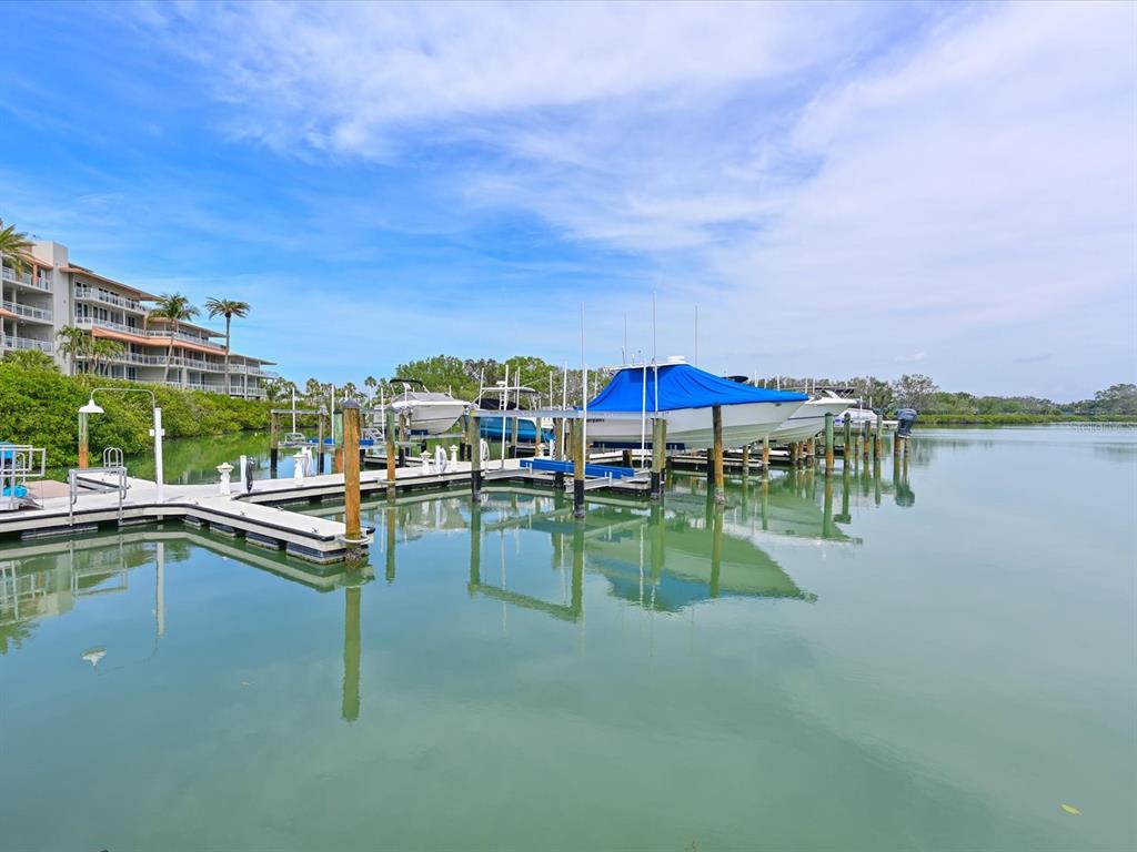 100 Sands Point Road, Unit 225 Longboat Key, FL 34228 - Photo 31 of 32 a view of swimming pool with outdoor seating and yard