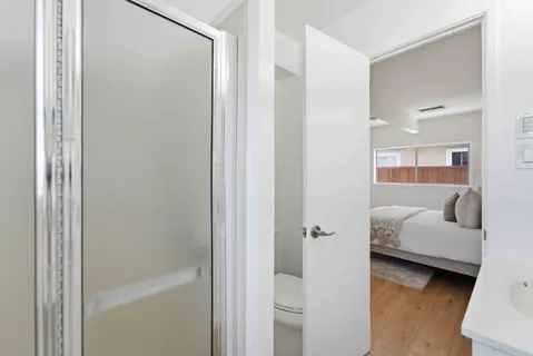 a en suite bathroom with a tub shower and bedroom