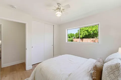a bedroom with a bed and a window