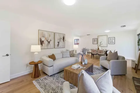 a living room with furniture and wooden floor