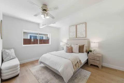 a bedroom with a bed couch and window