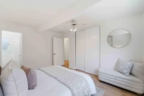 a bedroom with a large bed and a chandelier