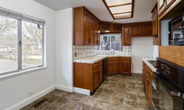 a kitchen with a sink stove and cabinets