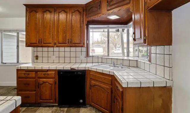 a kitchen that has a sink and a stove in it