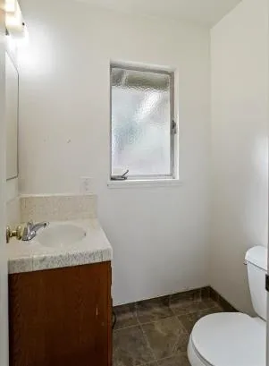 a bathroom with a sink toilet and mirror