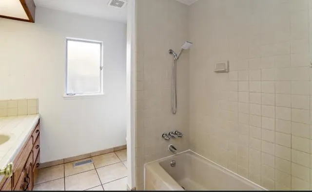 a bathroom with a bathtub and shower