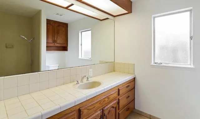 a bathroom with a sink and a mirror