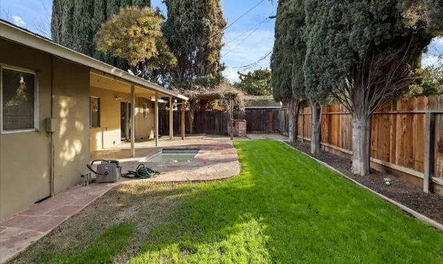a backyard of a house with yard and outdoor seating