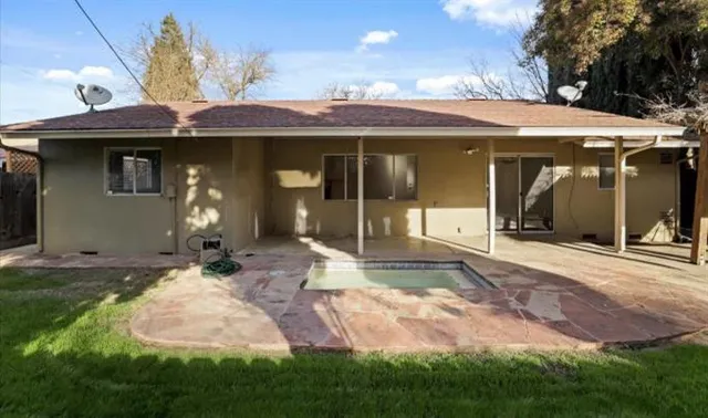 a view of a house with backyard porch and sitting area