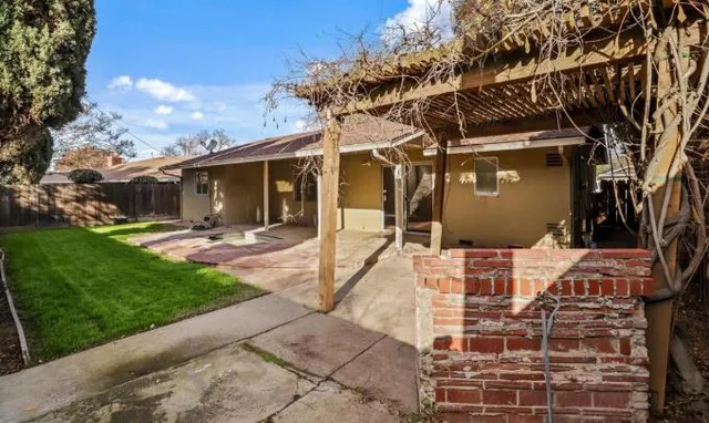a view of a patio with table and chairs with wooden floor and fence