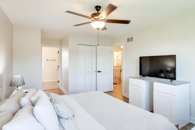 a bedroom with a bed and a flat screen tv