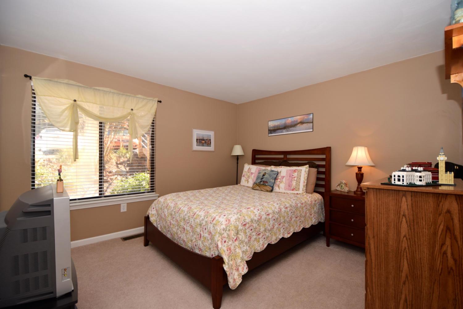 3323 Forest Ridge Road Roanoke, VA 24018 - Photo 11 of 23 a bed sitting in a bedroom next to a window