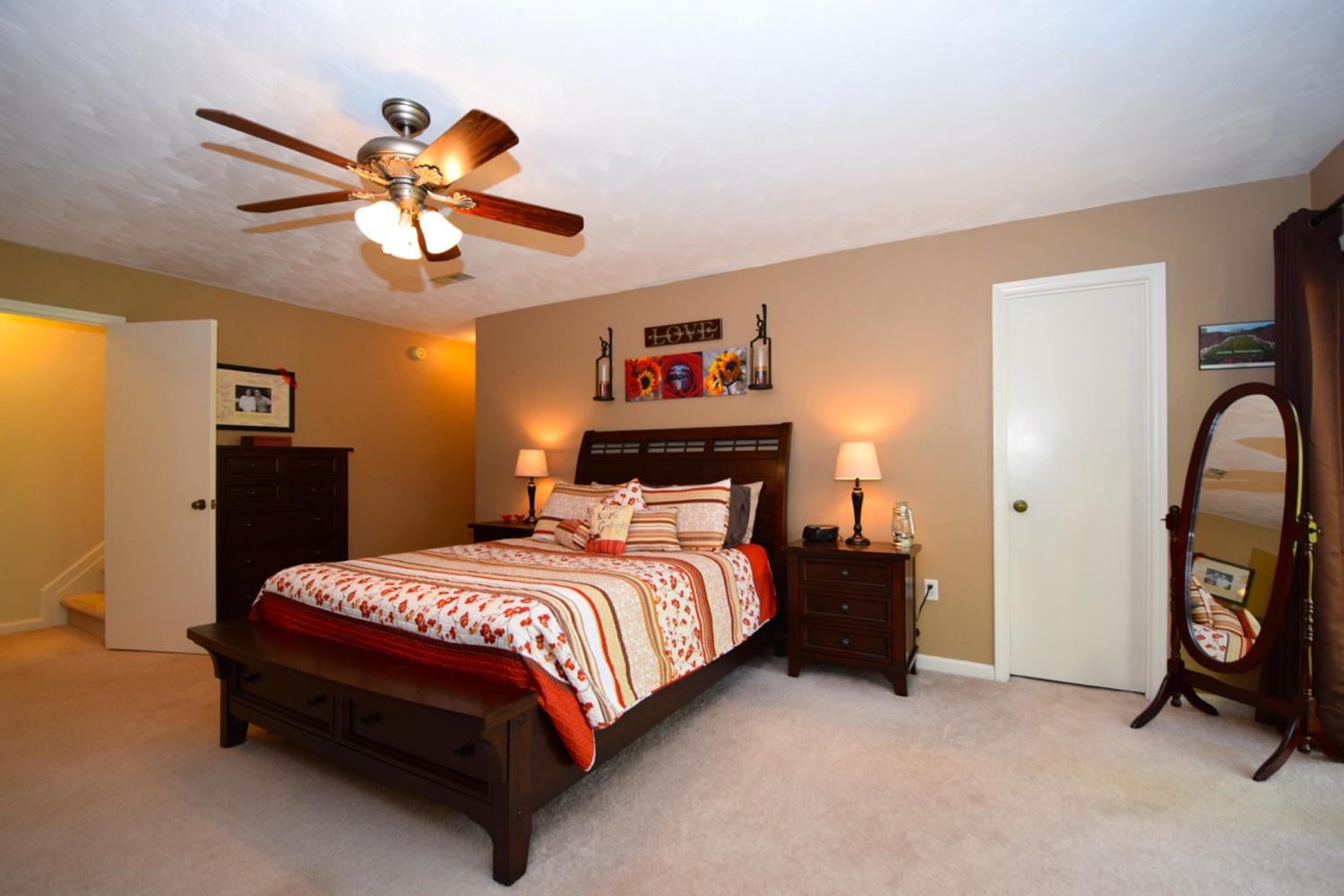 3323 Forest Ridge Road Roanoke, VA 24018 - Photo 15 of 23 a bedroom with a bed and a chandelier