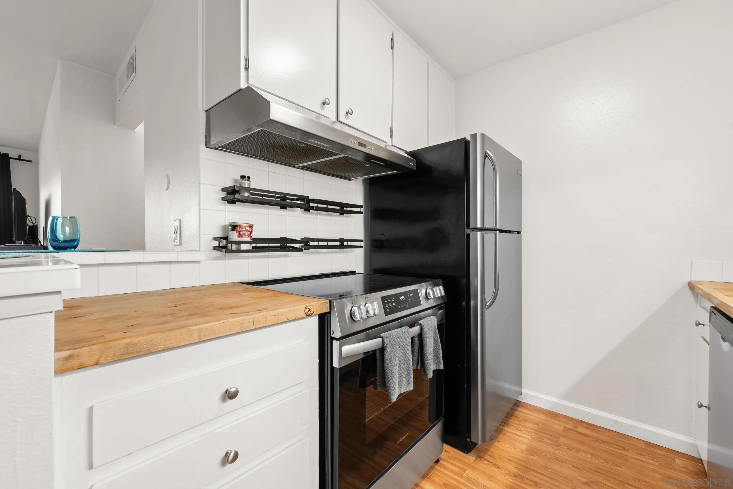 6202 Friars Road, Unit 215 San Diego, CA 92108 - Photo 2 of 18 a kitchen with stainless steel appliances and cabinets