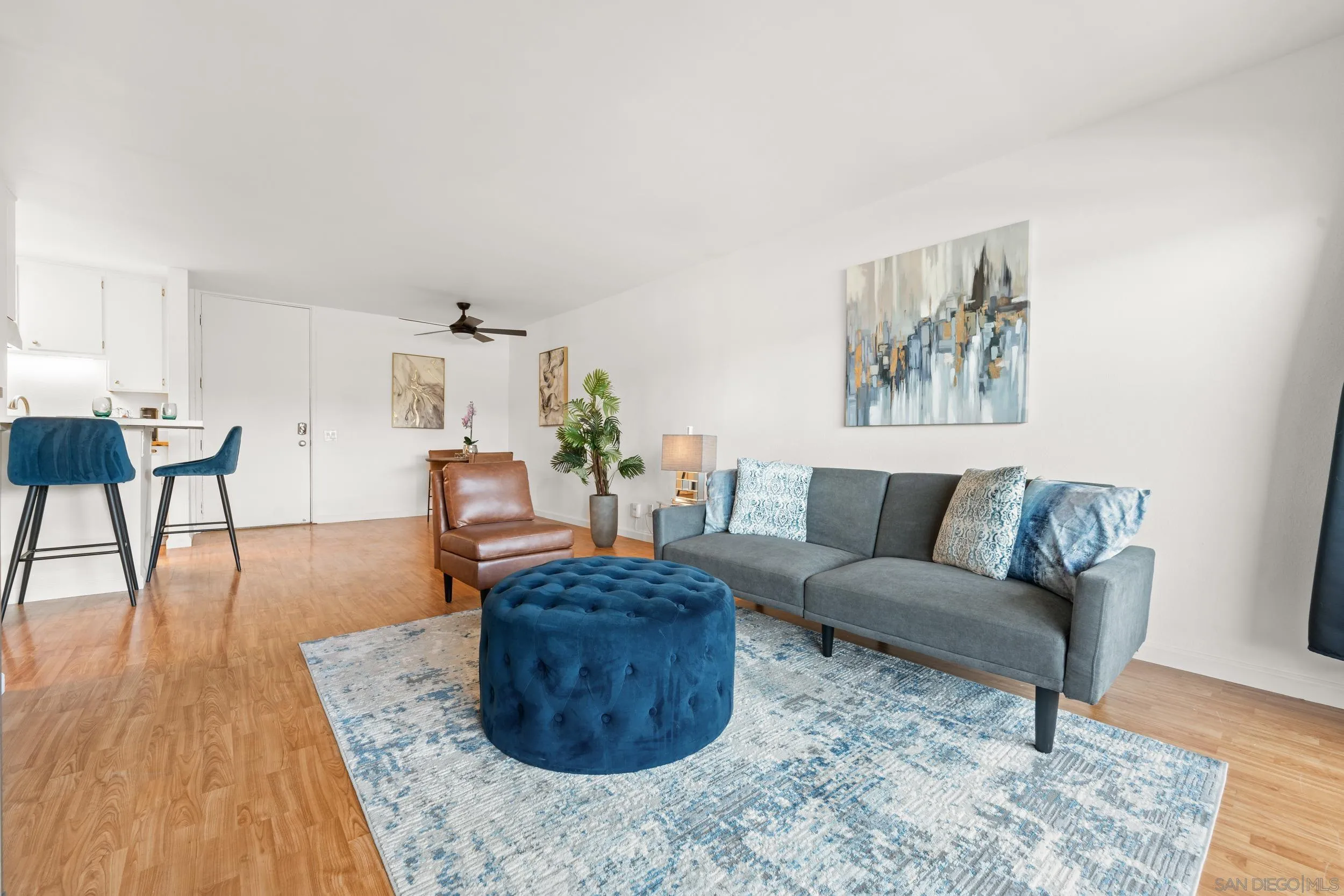 6202 Friars Road, Unit 215 San Diego, CA 92108 - Photo 8 of 18 a living room with furniture and a wooden floor