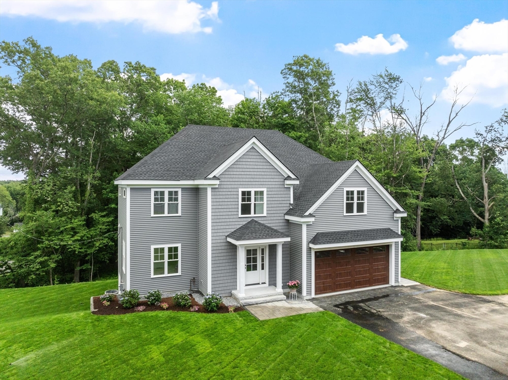 37 Dogwood Road Littleton, MA 01460 - Photo 25 of 36 a front view of a house with a yard and garage