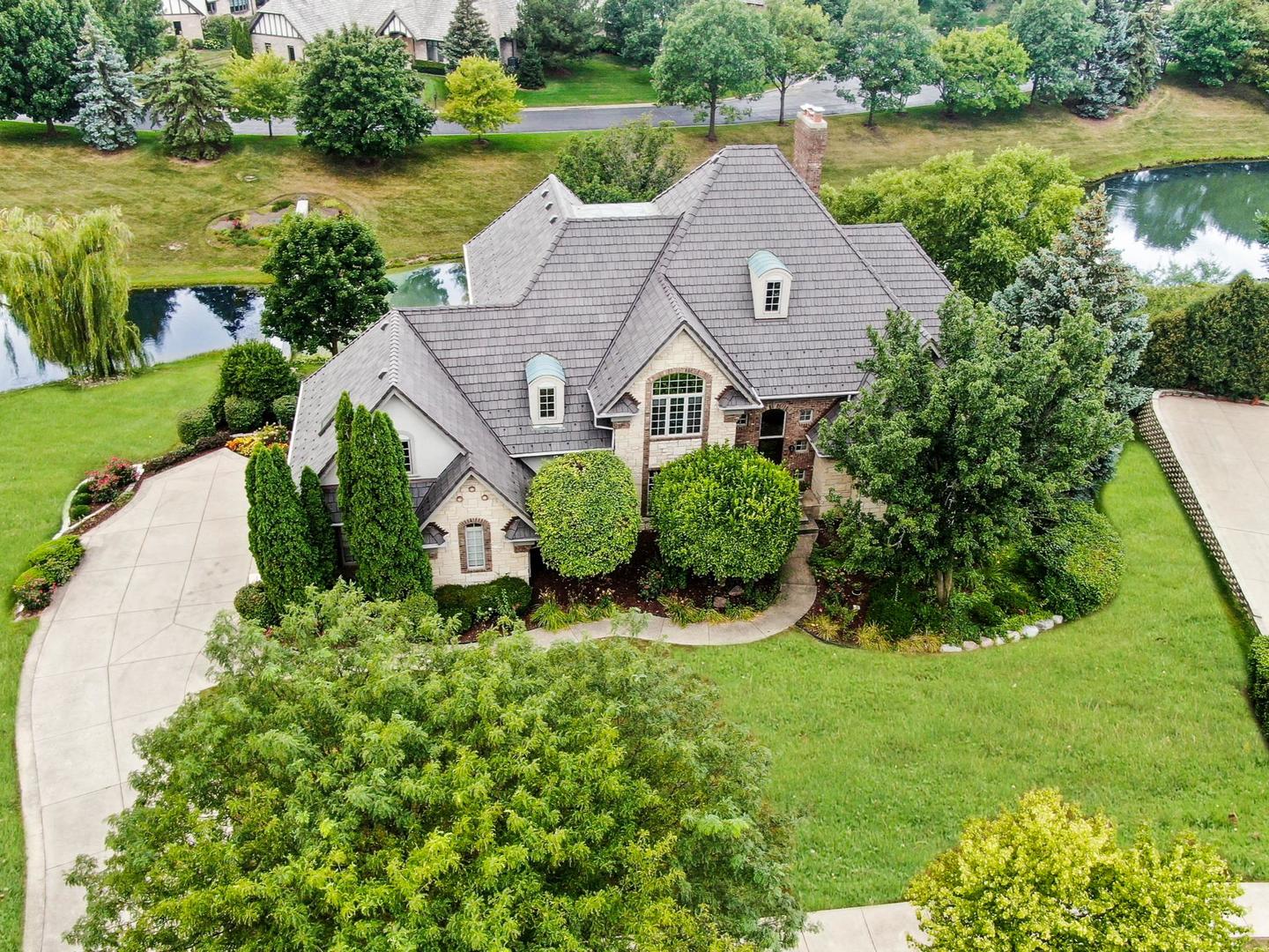 6972 Fieldstone Drive Burr Ridge, IL 60527 - Photo 1 of 2 an aerial view of a house with a yard and lake view
