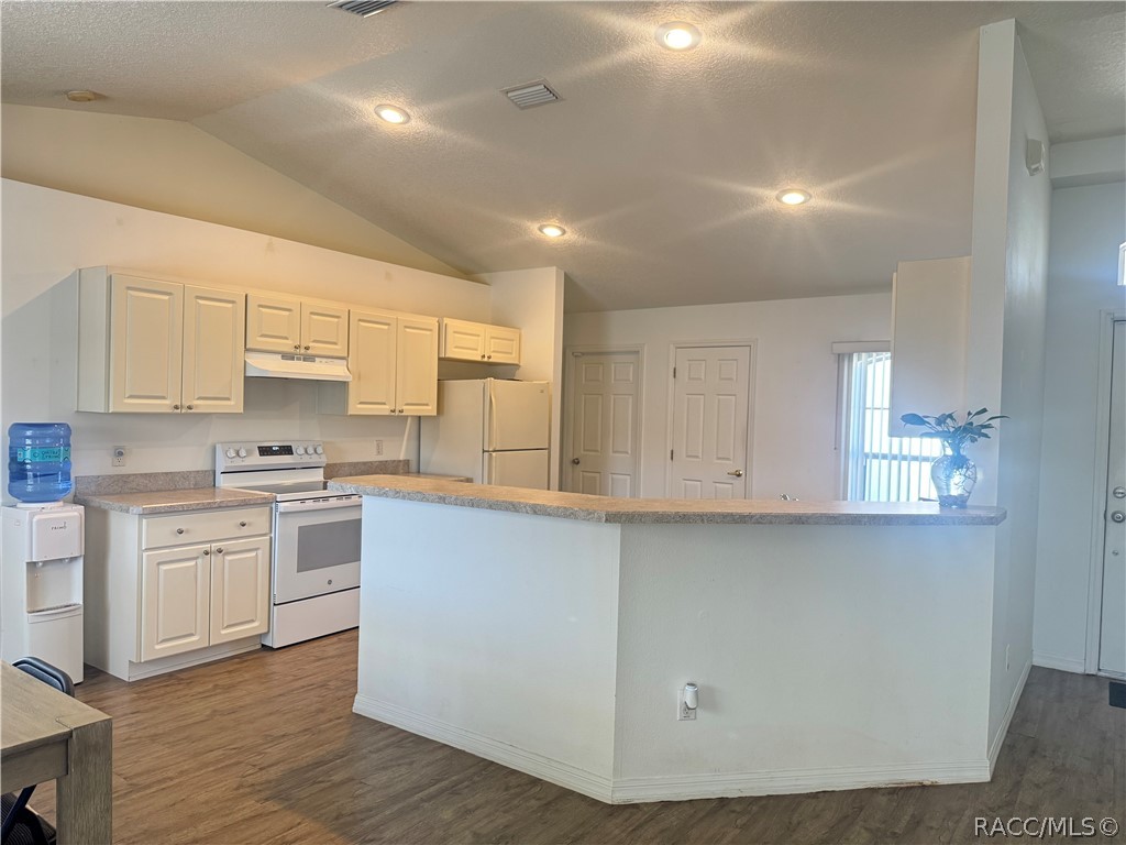 4588 East Van Ness Road Inverness, FL 34453 - Photo 9 of 34 a kitchen with white cabinets stainless steel appliances a sink and a window