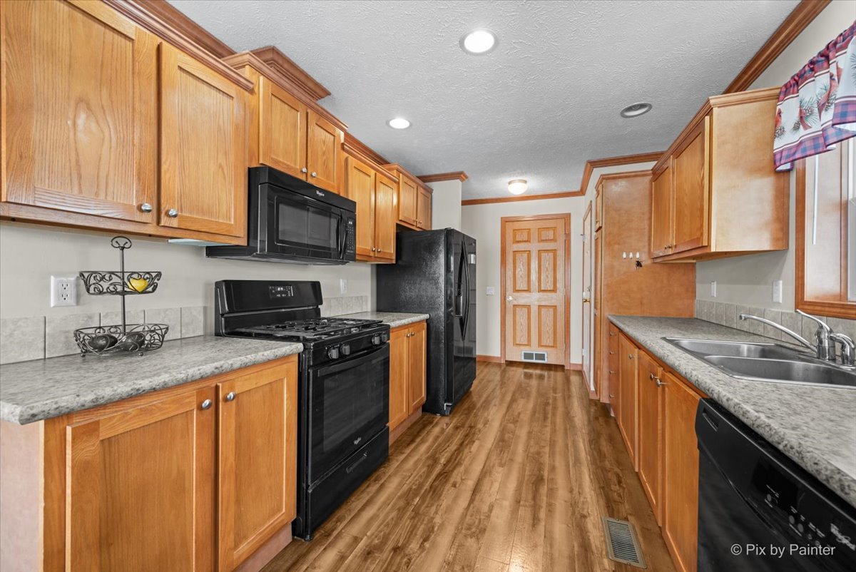 173 Northshore Road Elgin, IL 60123 - Photo 10 of 39 a kitchen with stainless steel appliances granite countertop wooden cabinets a stove top oven a sink and dishwasher