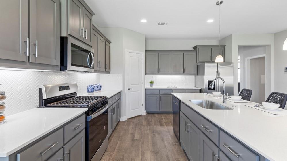 109 Hugo Court Rhome, TX 76078 - Photo 2 of 30 a kitchen with a sink stove top oven and cabinets