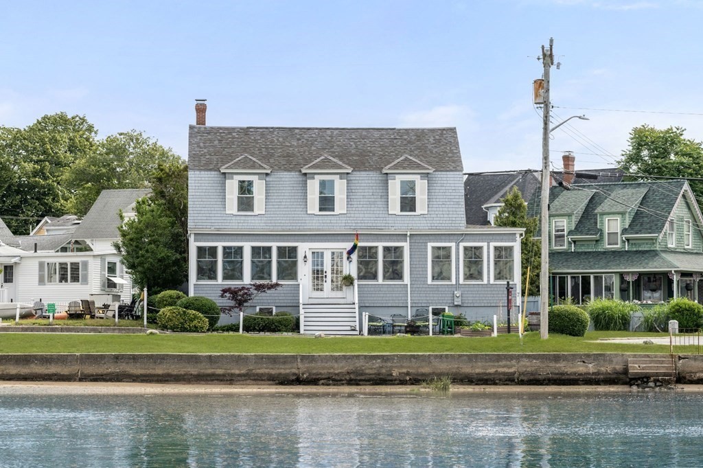 7 North Water Street Wareham, MA 02558 - Photo 1 of 39 a front view of a house with a yard and potted plants