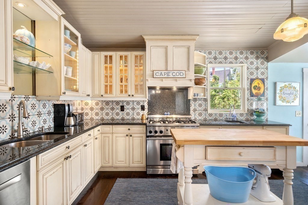7 North Water Street Wareham, MA 02558 - Photo 12 of 39 a kitchen with stainless steel appliances a stove and cabinets