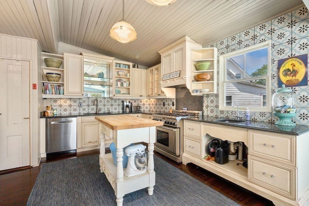 7 North Water Street Wareham, MA 02558 - Photo 13 of 39 a kitchen with granite countertop a sink a stove and cabinets