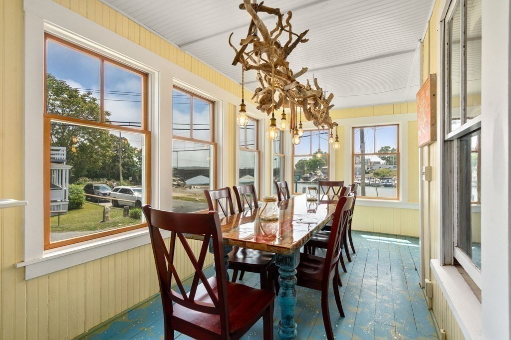7 North Water Street Wareham, MA 02558 - Photo 7 of 39 a view of a dining room with furniture wooden floor and a chandelier