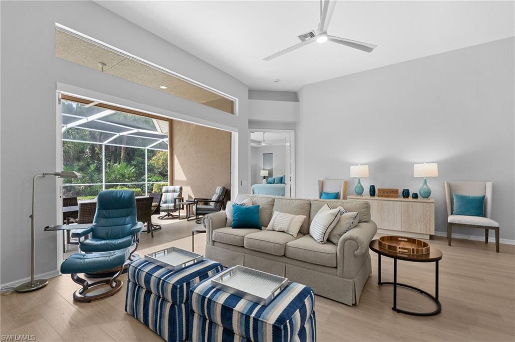 1717 Winding Oaks Way Naples, FL 34109 - Photo 9 of 29 a living room with furniture and a large window