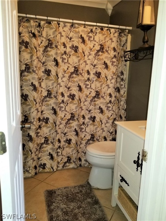 8201 Sandpiper Road Fort Myers, FL 33967 - Photo 11 of 11 a white toilet sitting next to a shower curtain