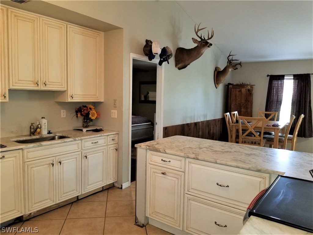 8201 Sandpiper Road Fort Myers, FL 33967 - Photo 6 of 11 a kitchen with white cabinets and sink