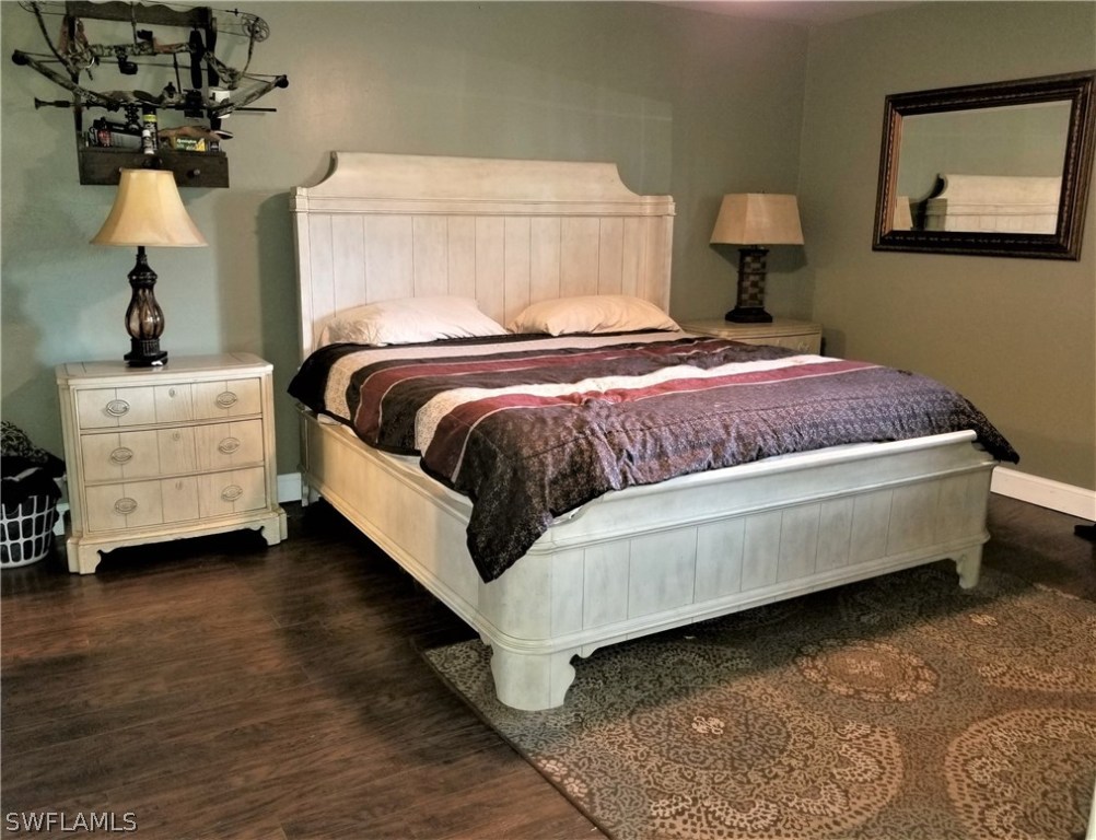 8201 Sandpiper Road Fort Myers, FL 33967 - Photo 8 of 11 a bed room with a bed and a night stand