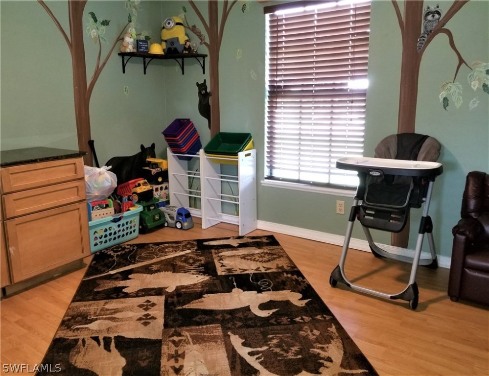 8201 Sandpiper Road Fort Myers, FL 33967 - Photo 10 of 11 a room with musical instruments and wooden floor