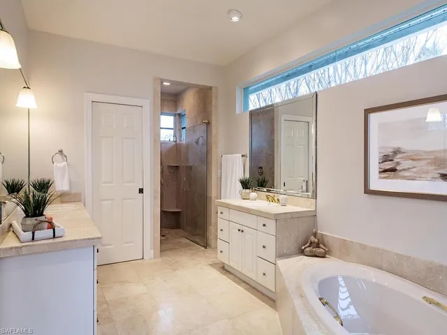 a bathroom with a tub sink and mirror