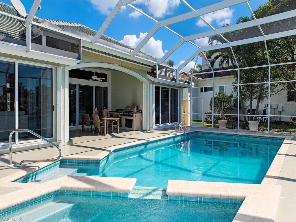 4459 Crayton Road Naples, FL 34103 - Photo 4 of 19 a view of a backyard with swimming pool and furniture