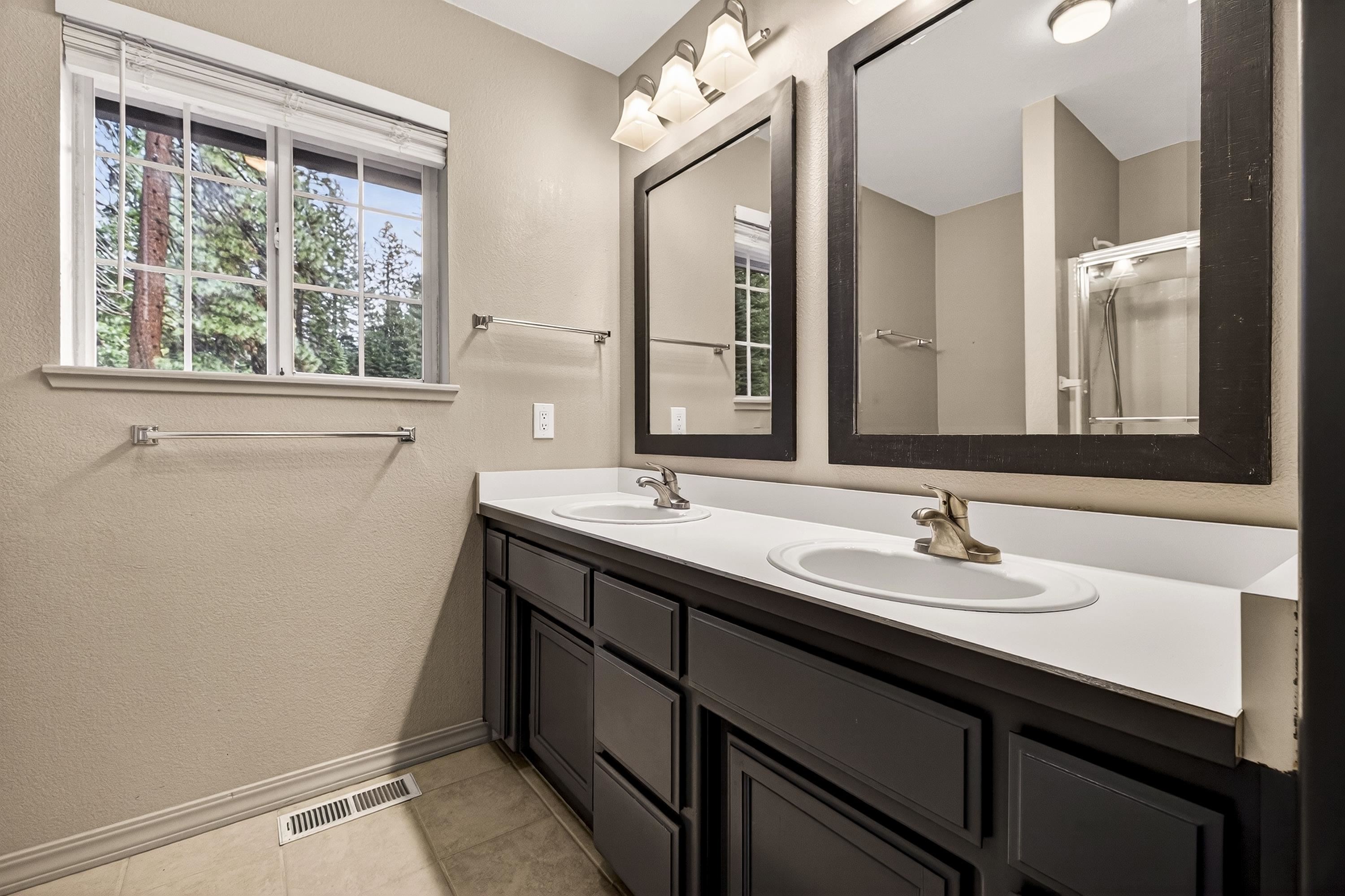 811 Golf Club Road Lake Almanor, CA 96137 - Photo 27 of 42 a bathroom with a sink a mirror and a window