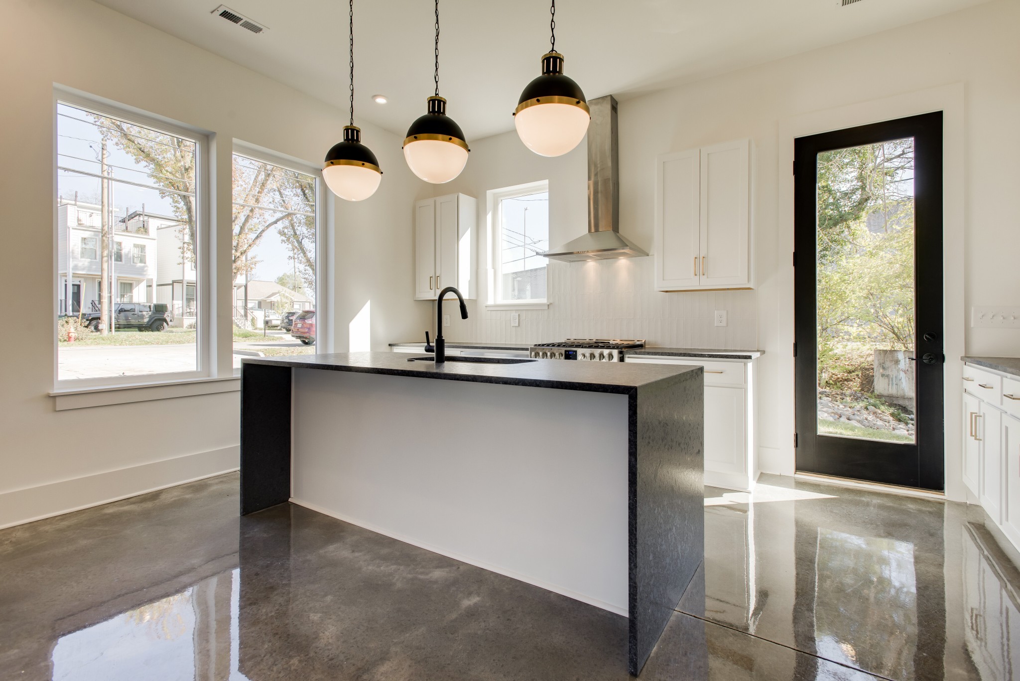 505 Croley Drive Nashville, TN 37209 - Photo 11 of 38 a kitchen with stainless steel appliances granite countertop a sink a stove and a large window