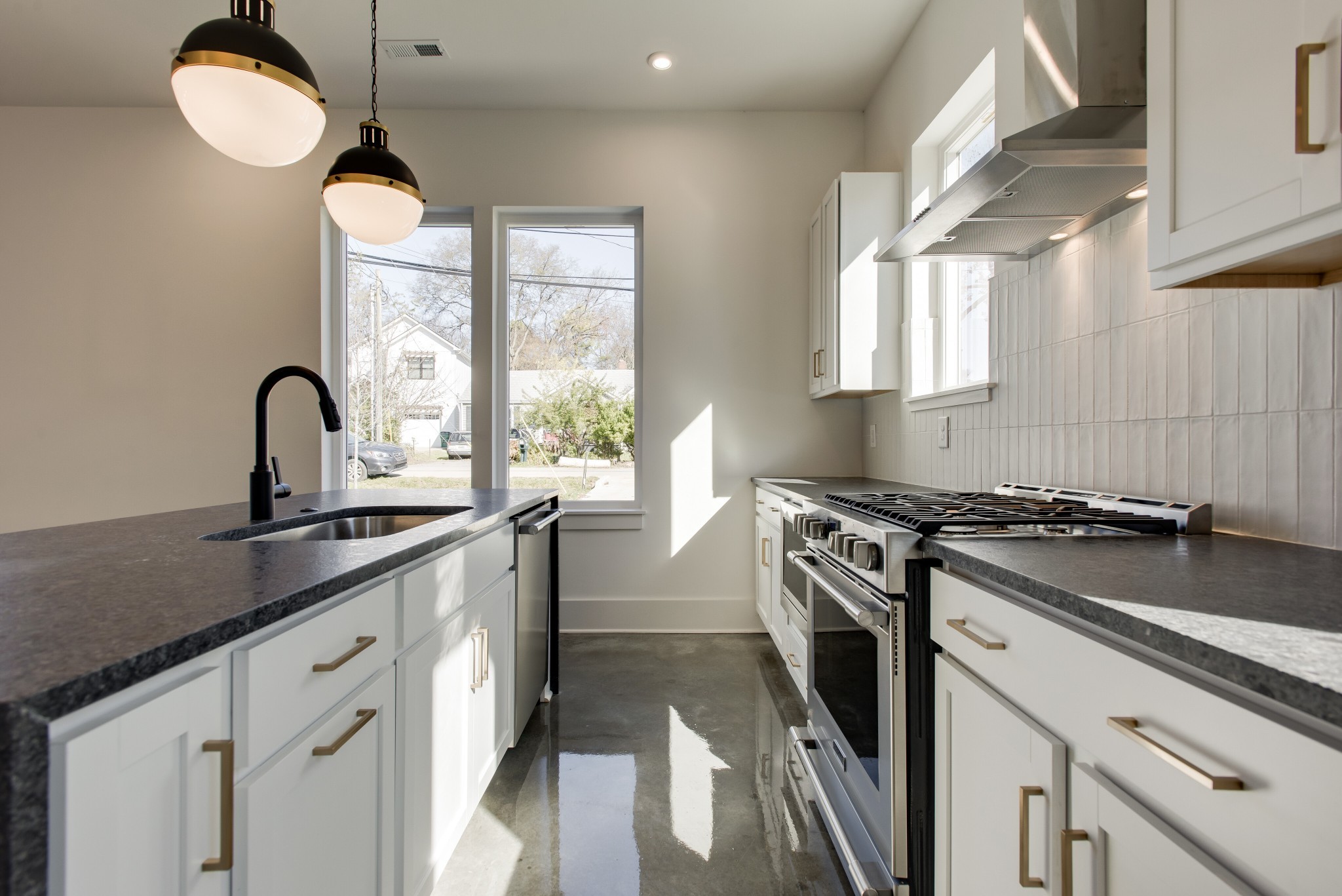505 Croley Drive Nashville, TN 37209 - Photo 12 of 38 a kitchen with granite countertop a sink stainless steel appliances a window and a counter space