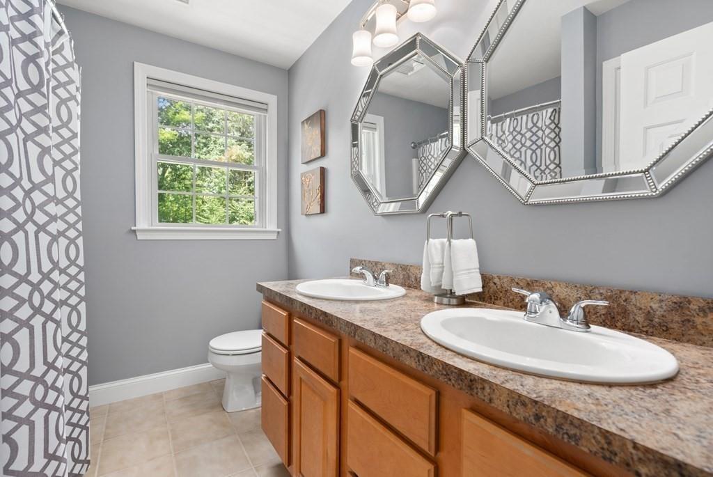 253 Walker Road Sturbridge, MA 01566 - Photo 24 of 31 a bathroom with a granite countertop sink a toilet and a mirror