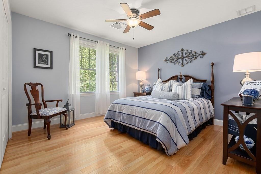 253 Walker Road Sturbridge, MA 01566 - Photo 27 of 31 a spacious bedroom with a bed and a chair