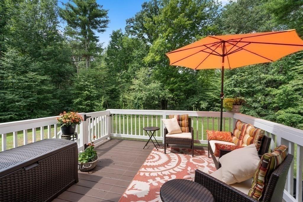 253 Walker Road Sturbridge, MA 01566 - Photo 28 of 31 a balcony with wooden floor and outdoor seating
