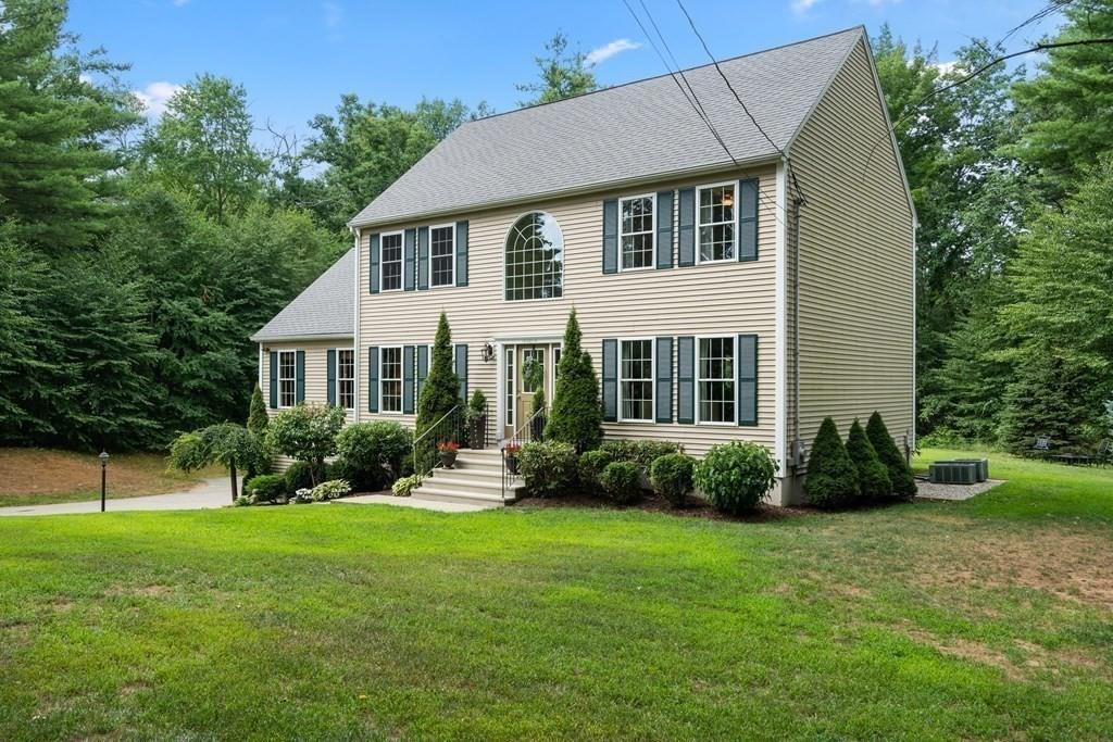 253 Walker Road Sturbridge, MA 01566 - Photo 3 of 31 a front view of a house with a yard and trees