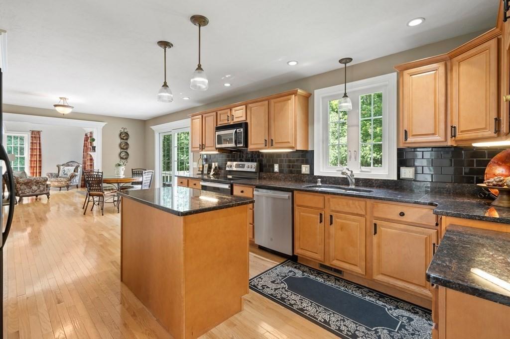 253 Walker Road Sturbridge, MA 01566 - Photo 6 of 31 a kitchen with stainless steel appliances granite countertop sink stove top oven and cabinets