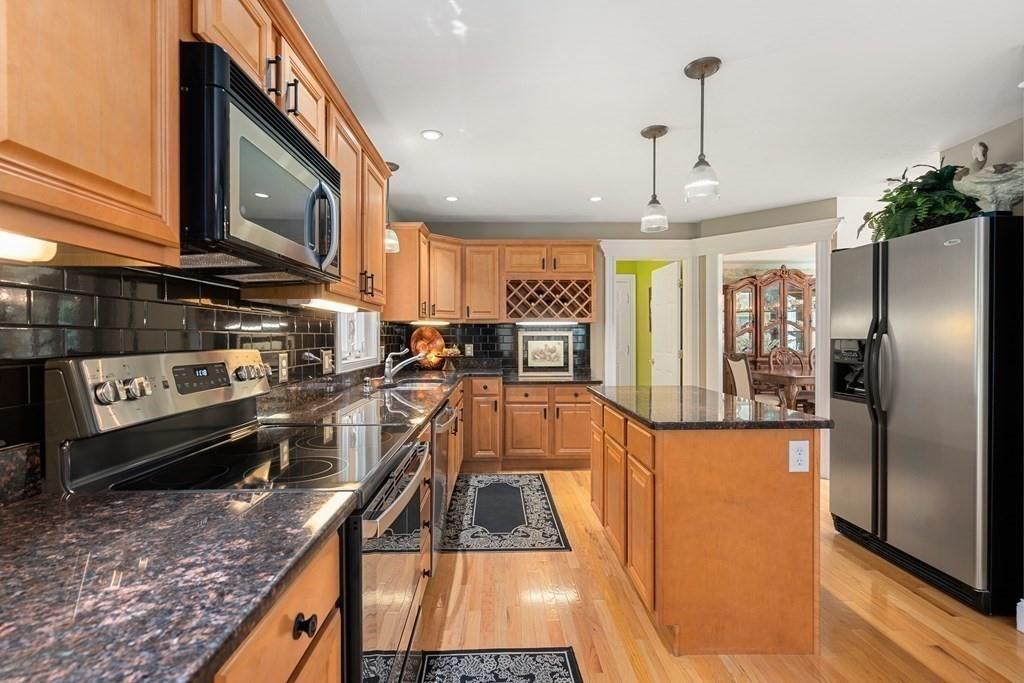 253 Walker Road Sturbridge, MA 01566 - Photo 9 of 31 a kitchen with stainless steel appliances granite countertop a refrigerator a stove top oven a sink and dishwasher