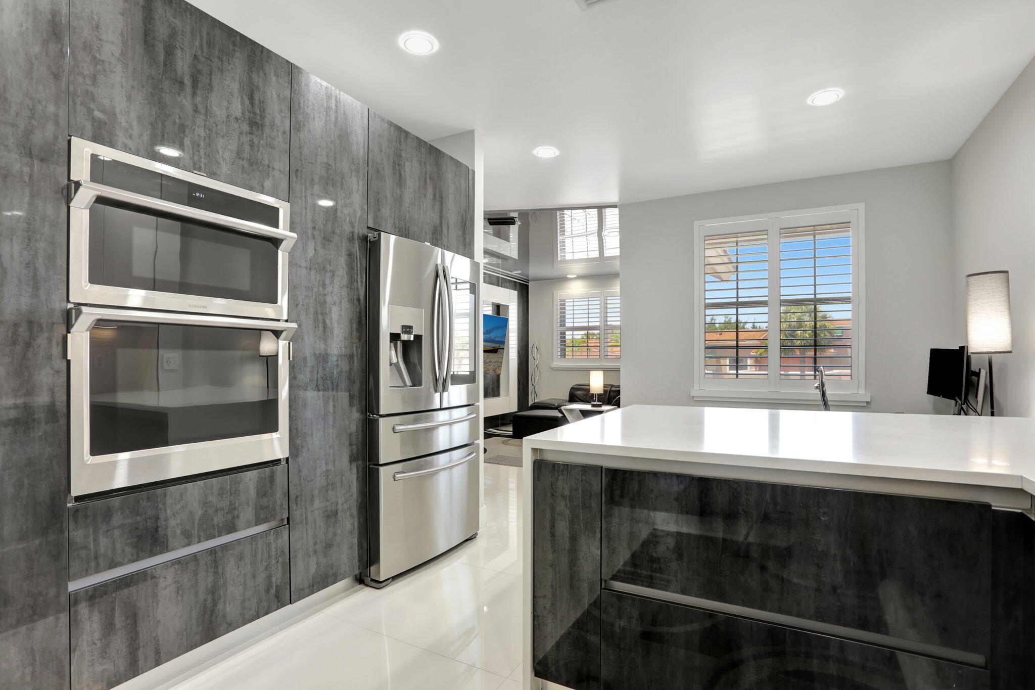 6584 Villa Sonrisa Drive, Unit 1122 Boca Raton, FL 33433 - Photo 11 of 22 a kitchen with granite countertop a refrigerator stove and microwave
