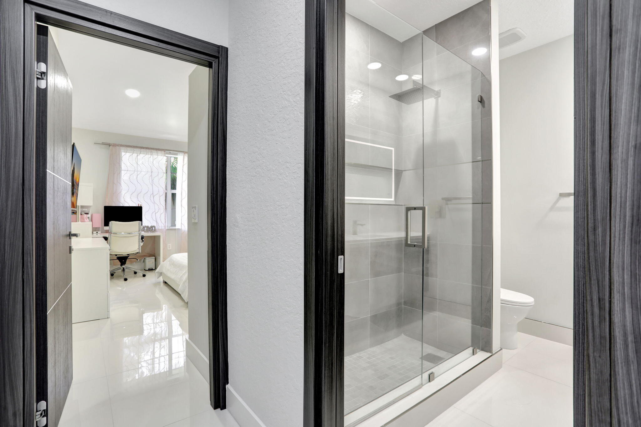 6584 Villa Sonrisa Drive, Unit 1122 Boca Raton, FL 33433 - Photo 15 of 22 a bathroom with a glass shower door