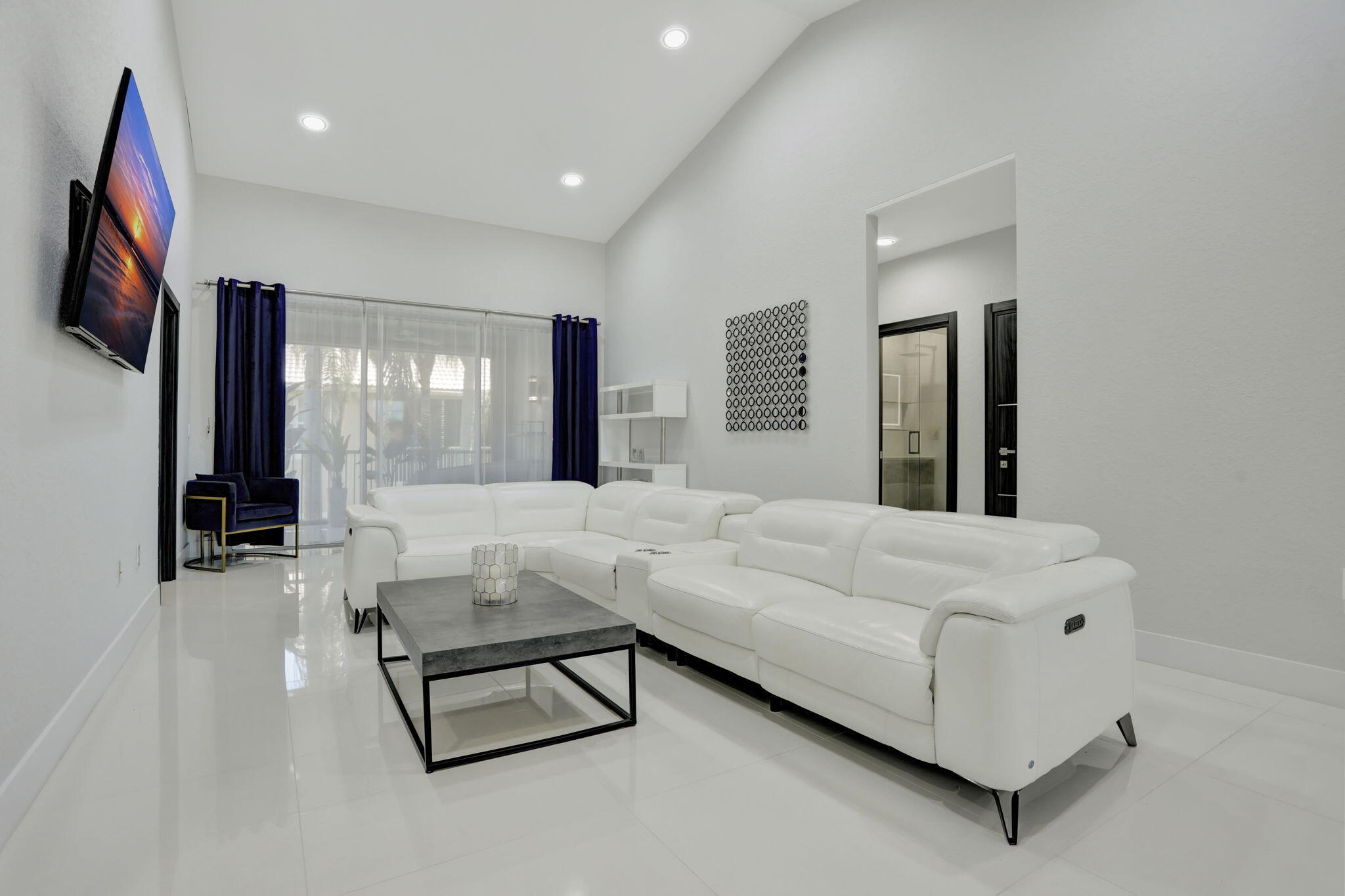 6584 Villa Sonrisa Drive, Unit 1122 Boca Raton, FL 33433 - Photo 7 of 22 a living room with furniture and a flat screen tv